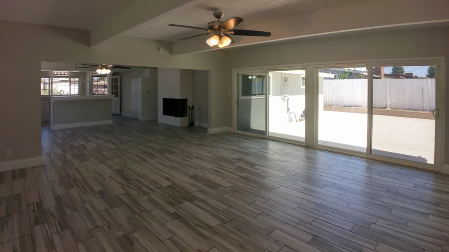 Open living and dining area with fireplace and sliding doors to the patio